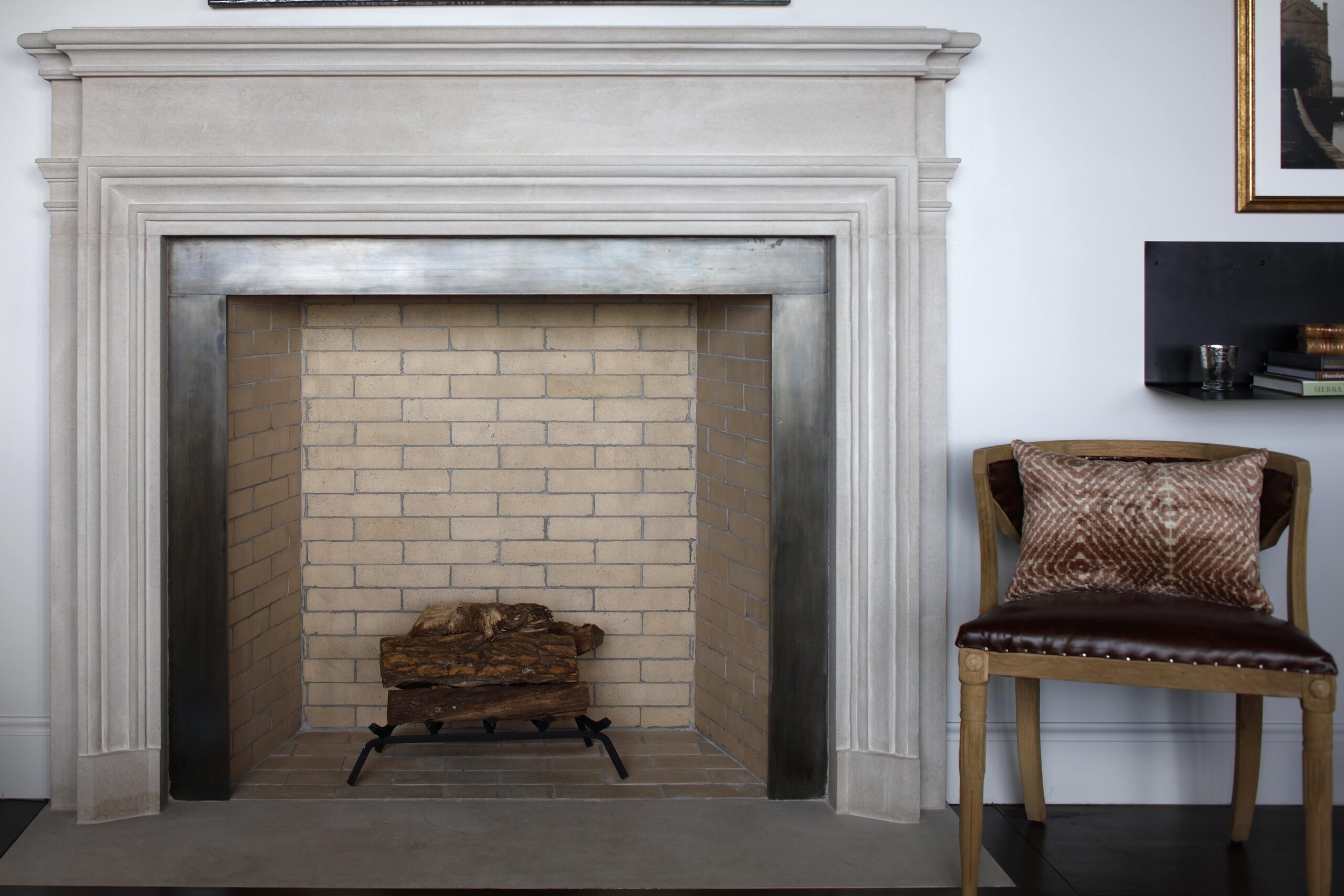 Indoor Fireplace with metal surround and limestone mantel